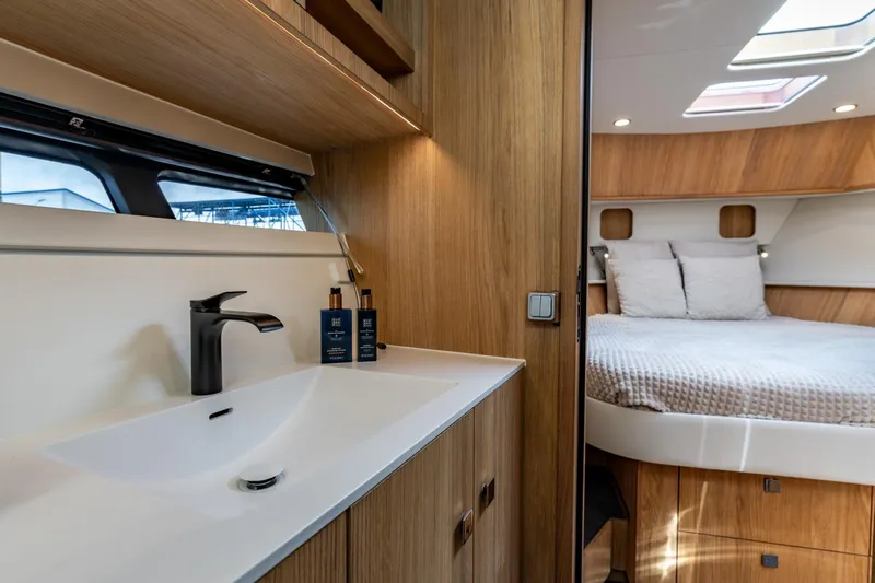  Yacht Photos Pics Luxurious interior of 2024 Vripack 42 Open Kuip yacht, featuring modern bathroom and cozy bedroom.