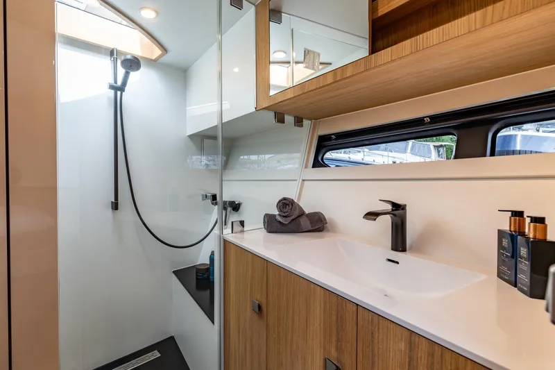  Yacht Photos Pics Luxurious bathroom in 2024 Vripack 42 Open Kuip yacht, featuring modern shower and sleek vanity.
