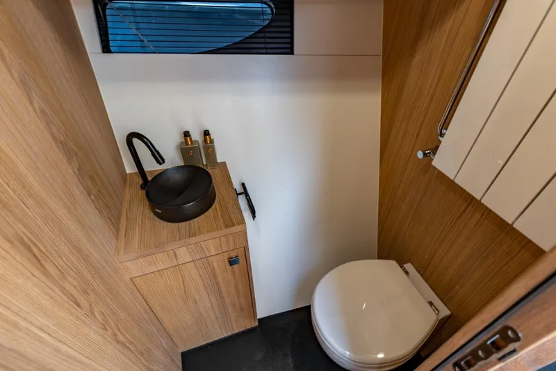  Yacht Photos Pics Modern bathroom interior on 2024 Vripack 42 Open Kuip yacht, featuring sleek wood finishes.