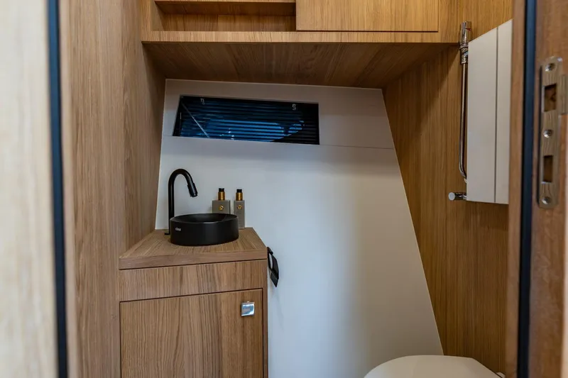  Yacht Photos Pics Modern bathroom interior on 2024 Vripack 42 Open Kuip yacht, featuring sleek wood finishes.