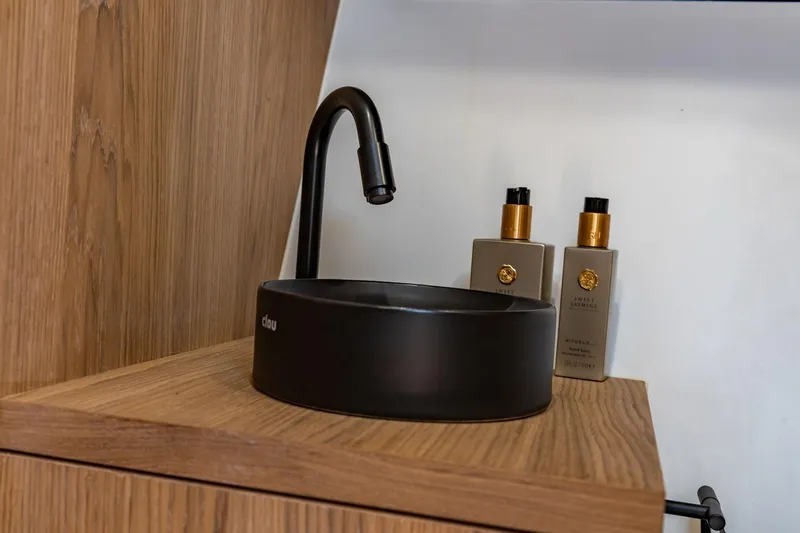  Yacht Photos Pics Modern black sink with faucet on wooden counter, Vripack 42 Open Kuip 2024 yacht interior.