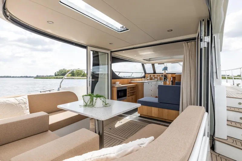  Yacht Photos Pics Luxurious interior of 2024 Vripack 42 Open Kuip yacht with modern seating and dining area.