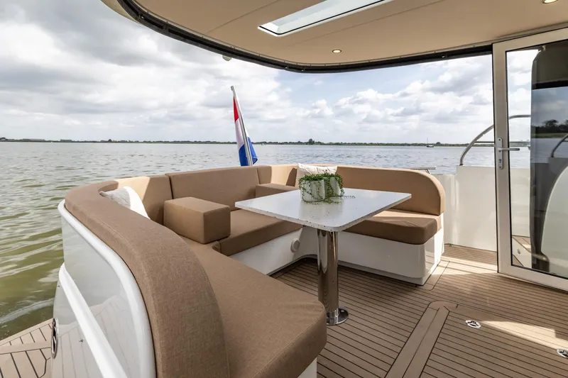  Yacht Photos Pics Luxurious 2024 Vripack 42 Open Kuip yacht with elegant seating and scenic water view.