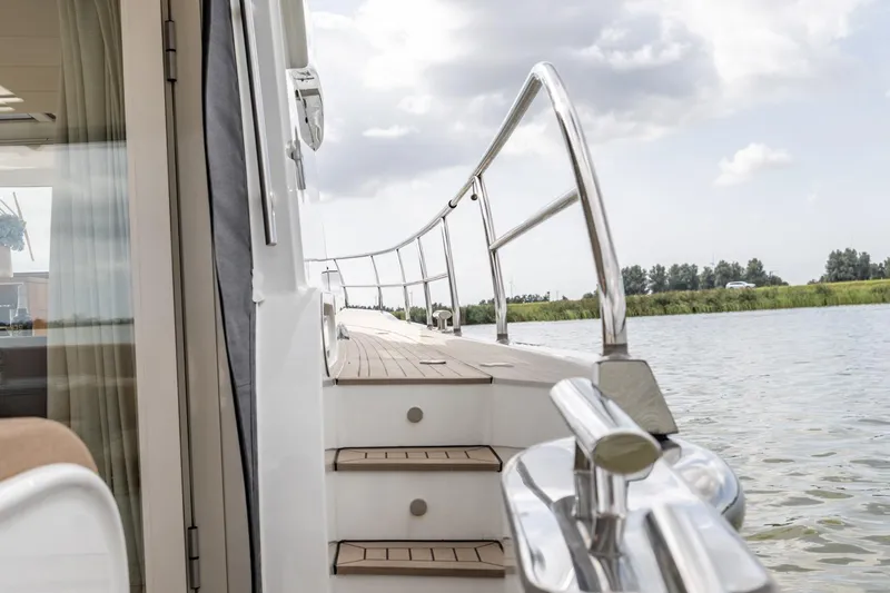  Yacht Photos Pics 2024 Vripack 42 Open Kuip yacht deck with railing, cruising on calm waters.