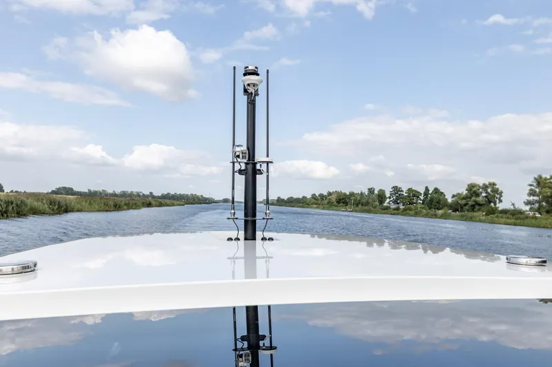  Yacht Photos Pics 2024 Vripack 42 Open Kuip yacht cruising on a serene river under a blue sky.