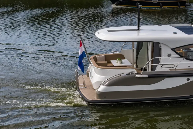  Yacht Photos Pics 2024 Vripack 42 Open Kuip yacht cruising on water with Dutch flag.