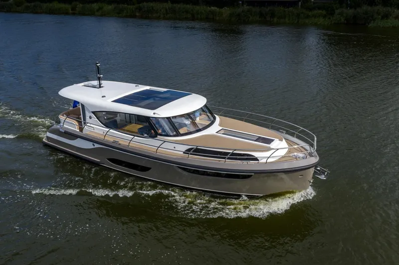  Yacht Photos Pics 2024 Vripack 42 Open Kuip yacht cruising on a calm river.