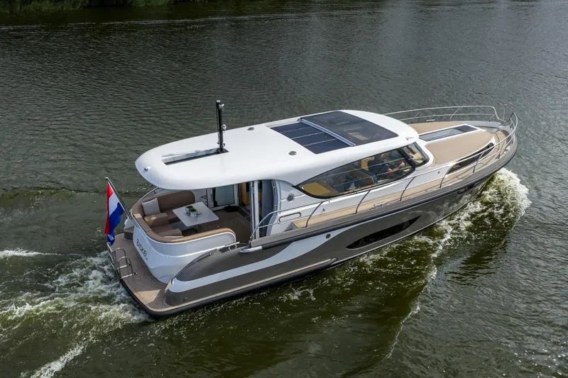  Yacht Photos Pics 2024 Vripack 42 Open Kuip yacht cruising on a calm waterway.