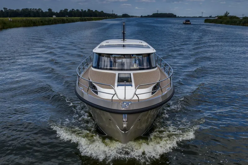  Yacht Photos Pics 2024 Vripack 42 Open Kuip yacht cruising on a serene waterway.