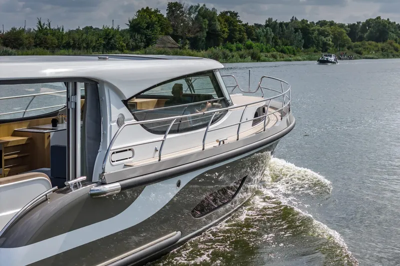  Yacht Photos Pics 2024 Vripack 42 Open Kuip yacht cruising on a scenic river.