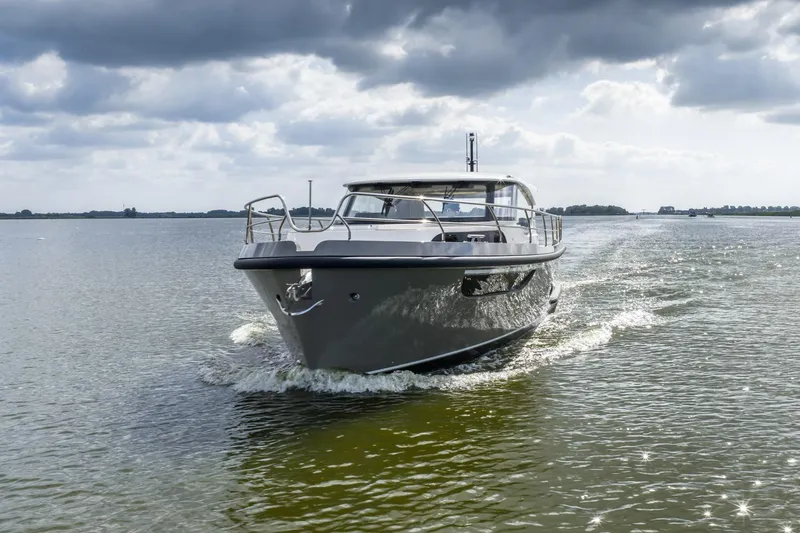  Yacht Photos Pics 2024 Vripack 42 Open Kuip yacht cruising on a calm, scenic waterway.