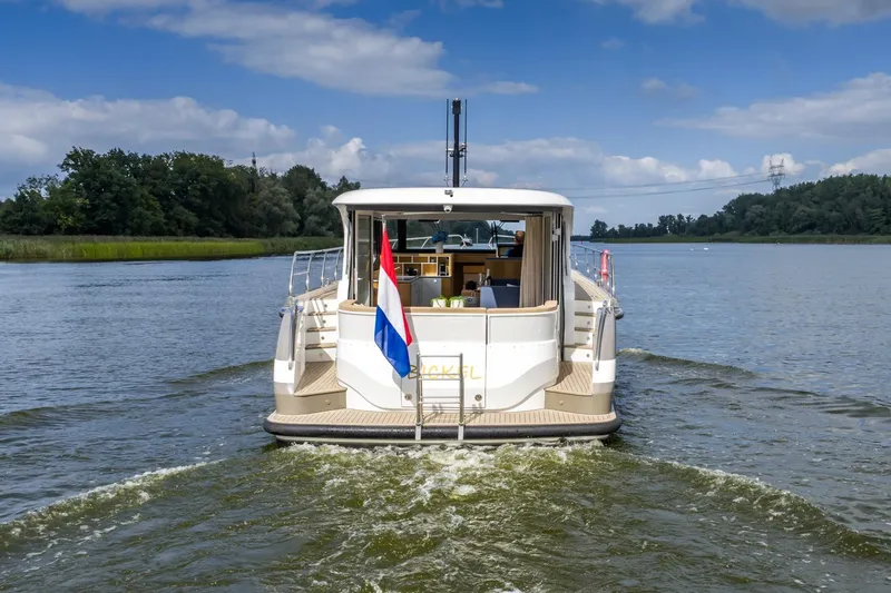  Yacht Photos Pics 2024 Vripack 42 Open Kuip yacht cruising on a serene river.