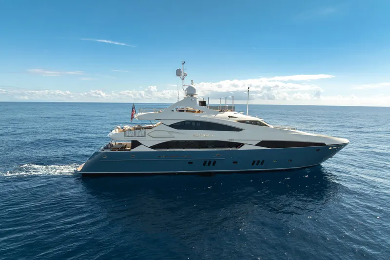 Natural 9 Yacht Photos Pics Luxurious 2009 Sunseeker 37 Metre Yacht cruising on open sea under clear blue sky.