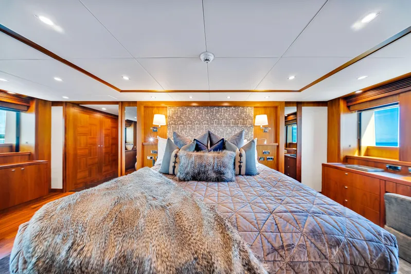 Natural 9 Yacht Photos Pics Luxurious bedroom interior on 2009 Sunseeker 37 Metre Yacht, featuring elegant wood finishes.