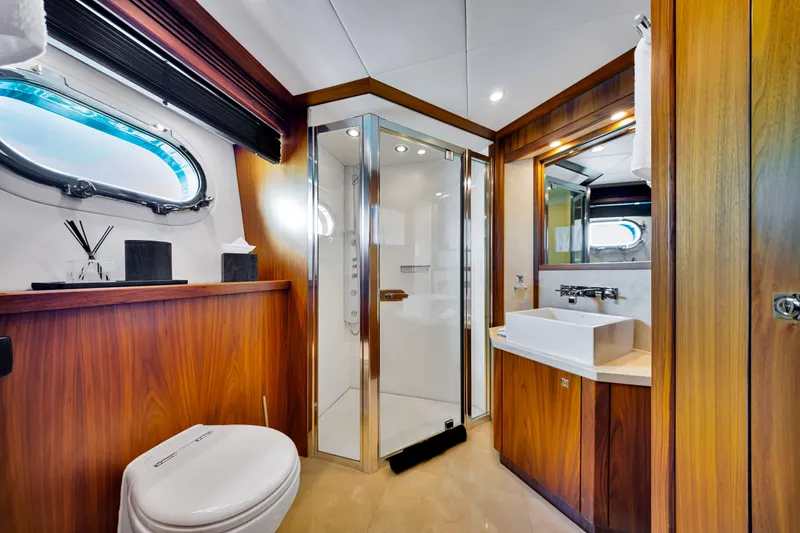 Natural 9 Yacht Photos Pics Luxurious bathroom on a 2009 Sunseeker 37 Metre Yacht, featuring wood accents and modern fixtures.