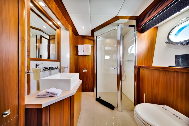 Natural 9 Yacht Photos Pics Luxurious bathroom on 2009 Sunseeker 37 Metre Yacht with wood accents and modern fixtures.