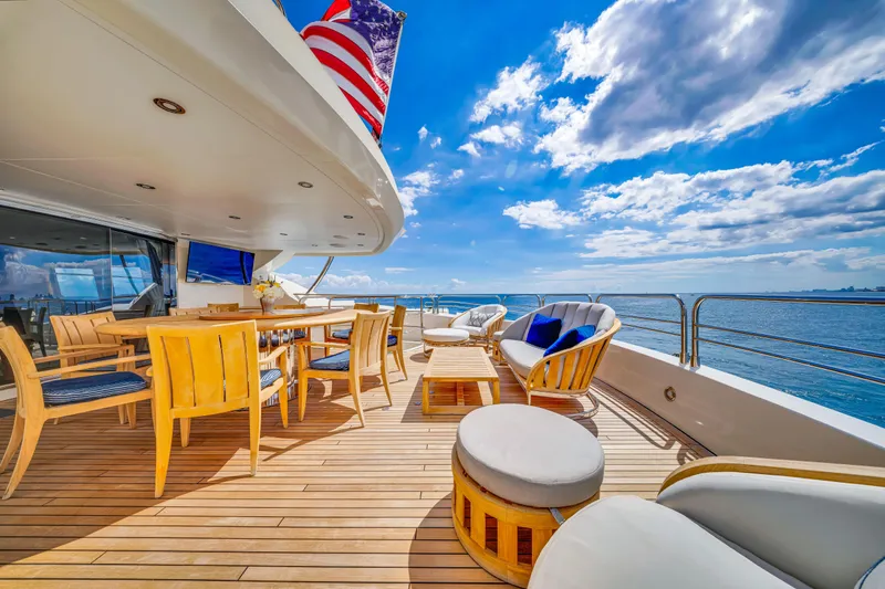 Natural 9 Yacht Photos Pics Luxurious Sunseeker 37 Metre Yacht deck with elegant seating, ocean view, and blue sky, 2009 model.