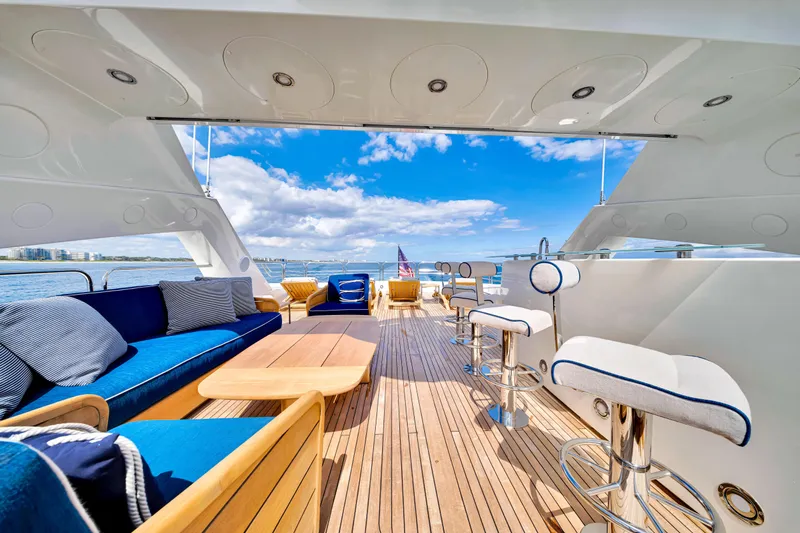 Natural 9 Yacht Photos Pics Luxurious Sunseeker 37 Metre Yacht deck with elegant seating, ocean view, and clear blue sky.