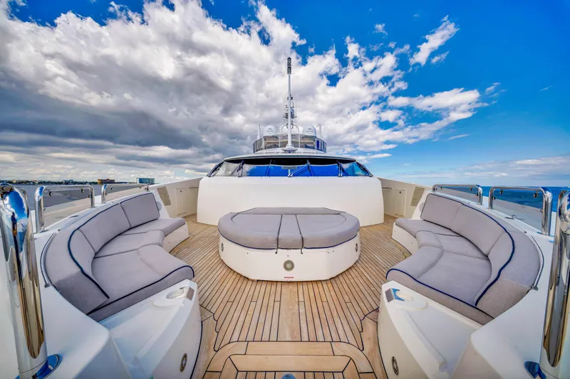 Natural 9 Yacht Photos Pics Luxurious 2009 Sunseeker 37 Metre Yacht deck with plush seating under a vibrant sky.