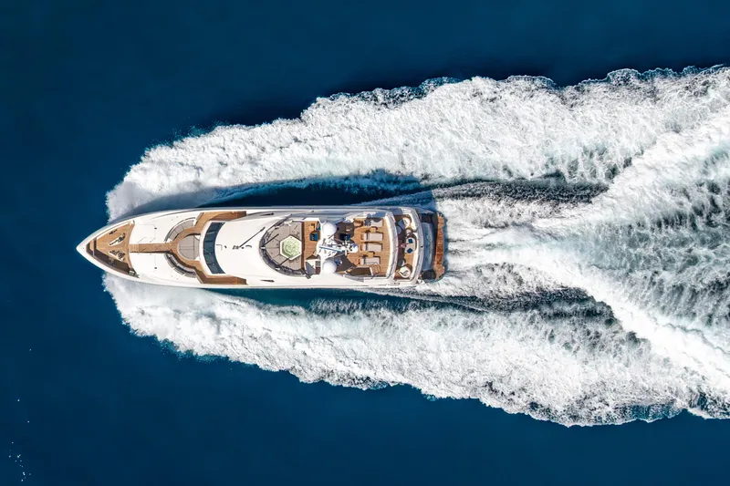 Natural 9 Yacht Photos Pics Aerial view of 2009 Sunseeker 37 Metre Yacht cruising on blue ocean.