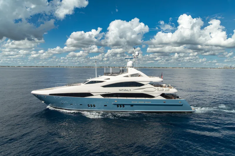 Natural 9 Yacht Photos Pics Luxurious 2009 Sunseeker 37 Metre Yacht cruising under a vibrant blue sky.
