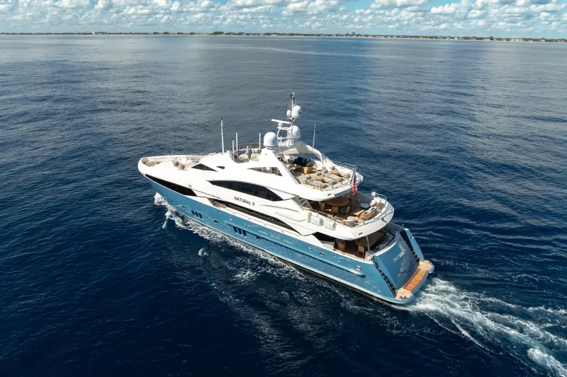 Natural 9 Yacht Photos Pics Luxurious 2009 Sunseeker 37 Metre Yacht cruising on open sea under blue sky.