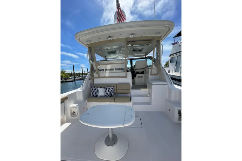 Sasea Yacht Photos Pics 2009 Tiara Yachts 4200 Open cockpit with seating, table, and American flag.