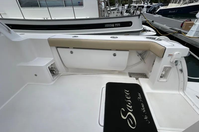 Sasea Yacht Photos Pics 2009 Tiara Yachts 4200 Open cockpit with seating and storage, docked at marina.