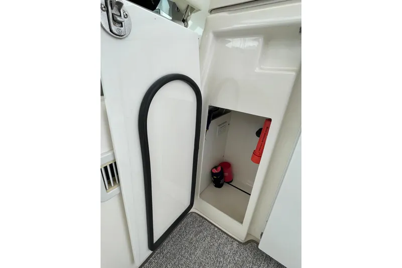 Sasea Yacht Photos Pics Open storage compartment on 2009 Tiara Yachts 4200 Open, featuring safety equipment.