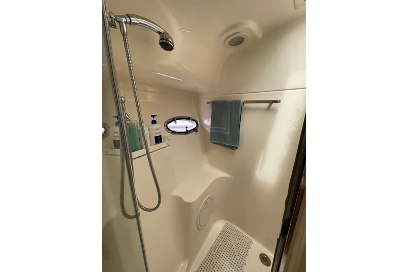 Sasea Yacht Photos Pics Shower area in 2009 Tiara Yachts 4200 Open, featuring modern fixtures and porthole window.