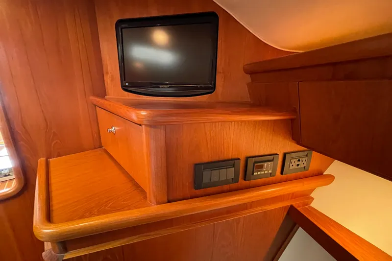 Sasea Yacht Photos Pics 2009 Tiara Yachts 4200 Open interior with TV, wooden cabinetry, and electrical outlets.