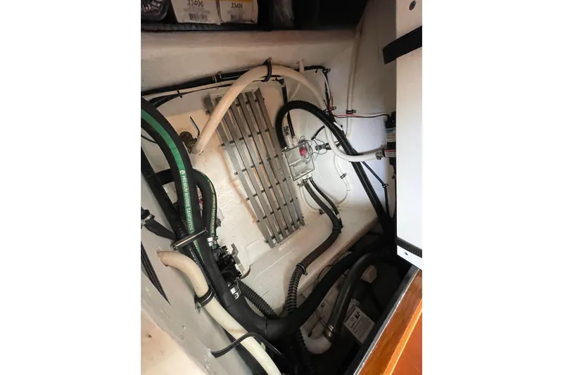 Sasea Yacht Photos Pics Engine room of 2009 Tiara Yachts 4200 Open, showcasing hoses and wiring.