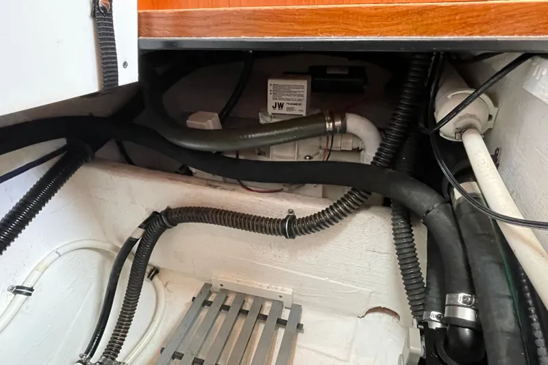 Sasea Yacht Photos Pics Engine compartment of a 2009 Tiara Yachts 4200 Open, showcasing hoses and mechanical components.