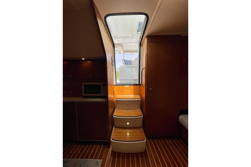Sasea Yacht Photos Pics Interior view of 2009 Tiara Yachts 4200 Open, featuring wooden steps and cabinetry.