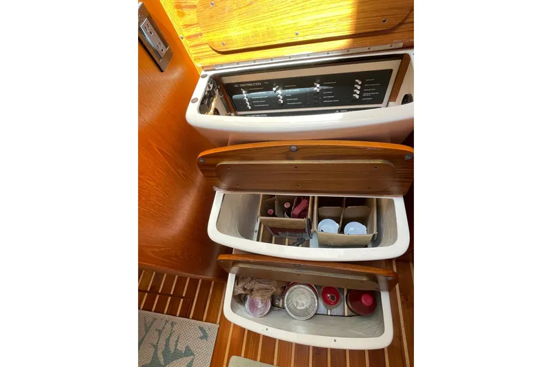 Sasea Yacht Photos Pics 2009 Tiara Yachts 4200 Open interior storage compartments with wooden finish and organized items.