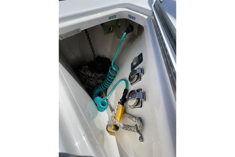 Sasea Yacht Photos Pics 2009 Tiara Yachts 4200 Open boat compartment with coiled hose and rope.