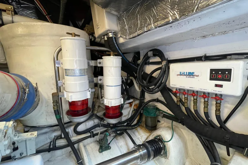 Sasea Yacht Photos Pics Engine room of 2009 Tiara Yachts 4200 Open, showcasing fuel filters and control panel.