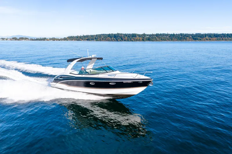  Yacht Photos Pics 2013 Formula 310 Sun Sport cruising on a serene blue lake.