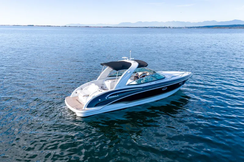  Yacht Photos Pics 2013 Formula 310 Sun Sport boat cruising on calm blue waters.