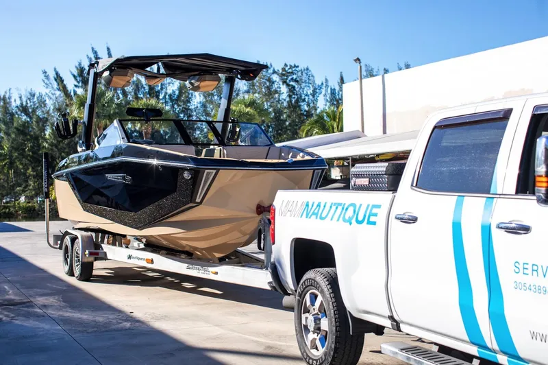  Yacht Photos Pics 2025 Nautique Super Air Nautique G25 boat on trailer, hitched to service truck.