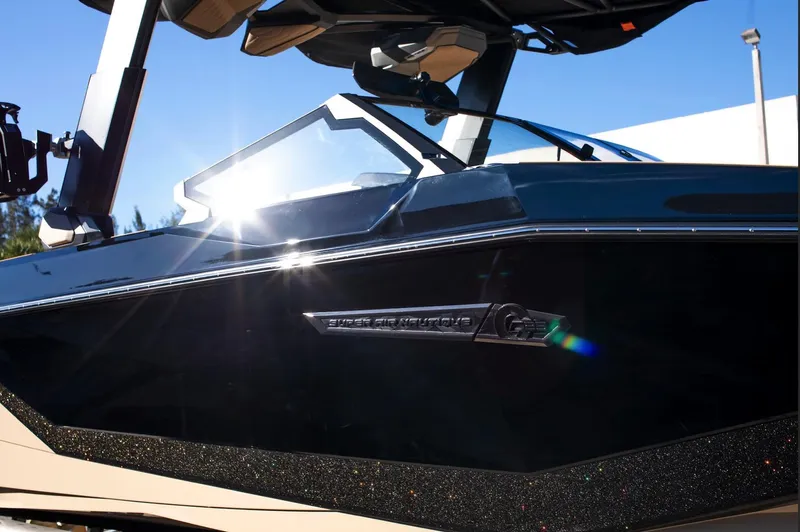  Yacht Photos Pics 2025 Nautique Super Air Nautique G25 boat with sleek design and sunlit exterior.