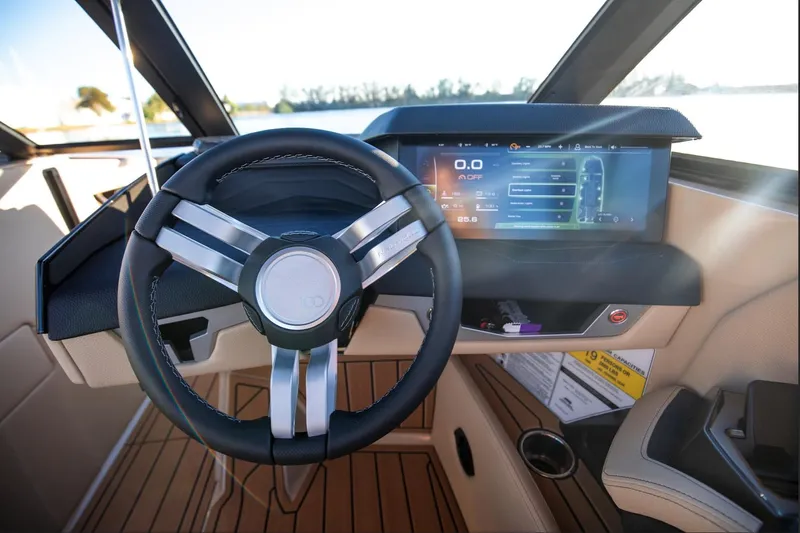  Yacht Photos Pics 2025 Nautique Super Air Nautique G25 dashboard with modern steering wheel and digital display.