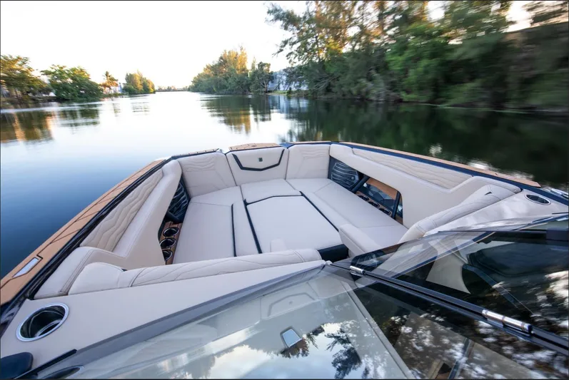  Yacht Photos Pics 2025 Nautique Super Air Nautique G25 boat interior on a serene waterway.