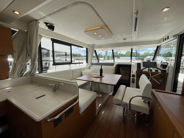  Yacht Photos Pics Interior of 2023 Beneteau Swift Trawler 41 Fly, featuring modern seating and helm station.