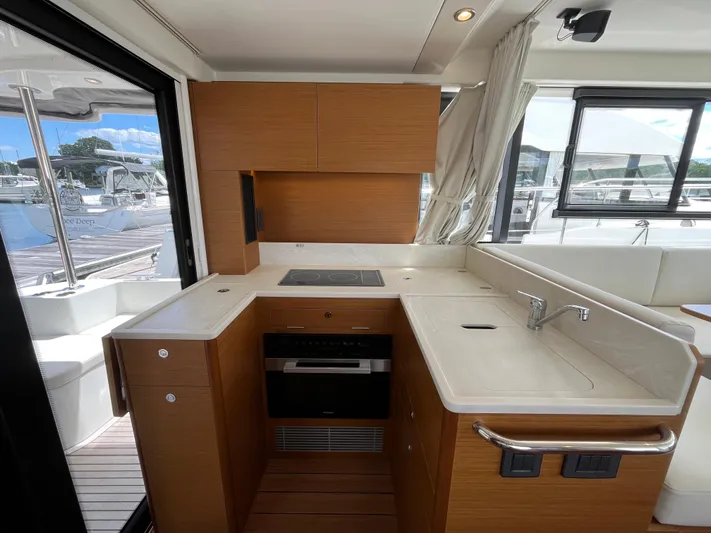  Yacht Photos Pics Modern kitchen in 2023 Beneteau Swift Trawler 41 Fly yacht with wood cabinetry and appliances.
