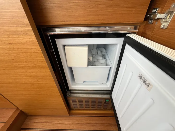  Yacht Photos Pics Ice maker inside 2023 Beneteau Swift Trawler 41 Fly, wooden cabinetry.