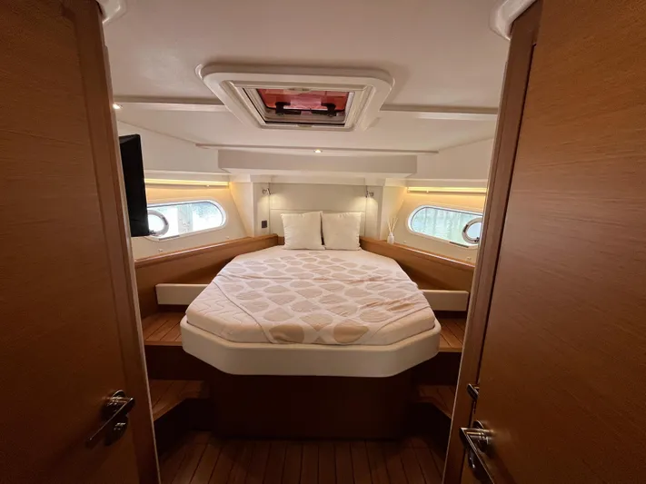  Yacht Photos Pics 2023 Beneteau Swift Trawler 41 Fly cabin with a cozy bed and elegant wood finish.