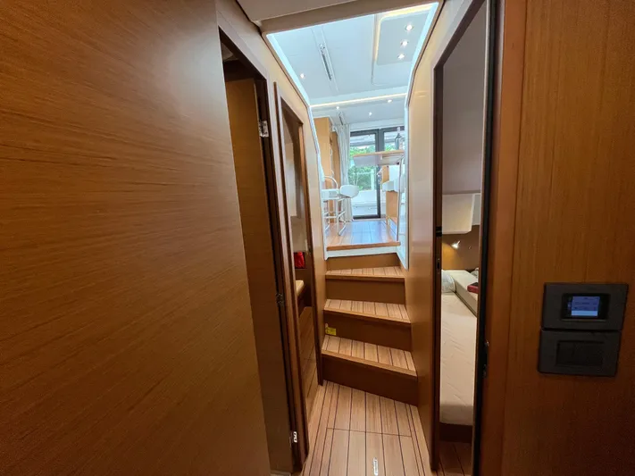  Yacht Photos Pics Interior view of 2023 Beneteau Swift Trawler 41 Fly, featuring wooden stairs and modern design.
