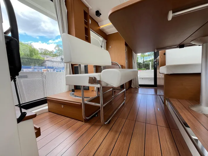  Yacht Photos Pics Interior of 2023 Beneteau Swift Trawler 41 Fly with wood flooring and seating.
