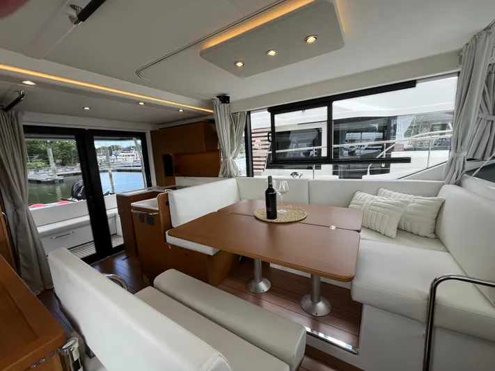  Yacht Photos Pics Interior of 2023 Beneteau Swift Trawler 41 Fly with elegant seating and dining area.